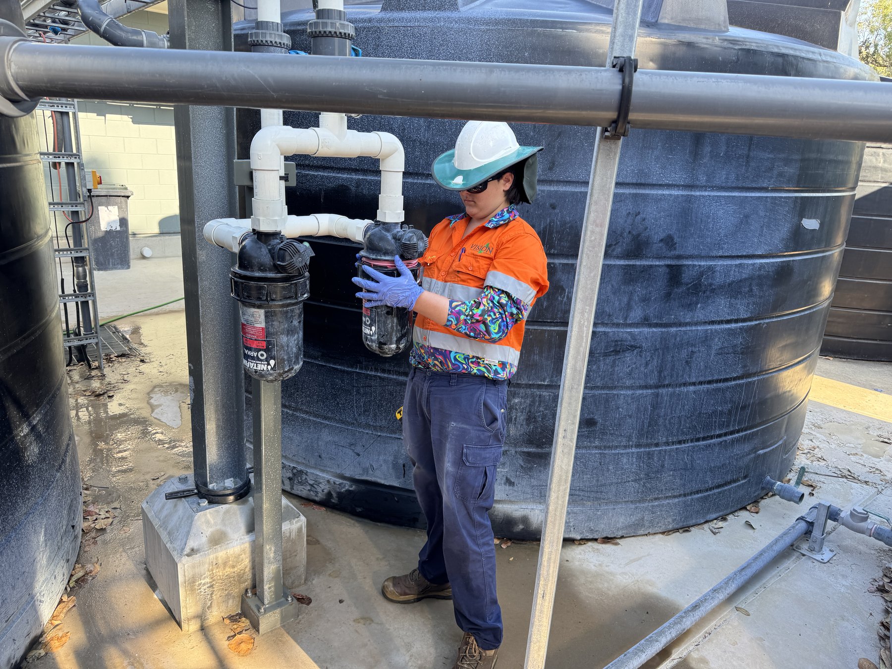 Vision crew member servicing water tank filters